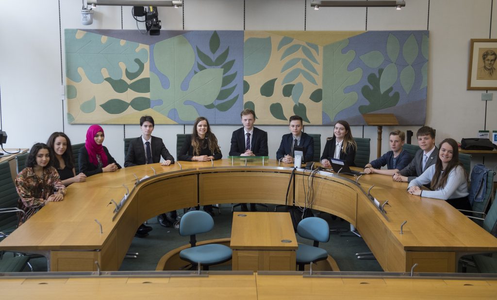 the youth select committee sat around a table