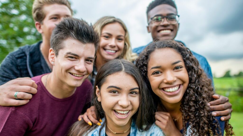 Group of young people huddled together for a photograph.