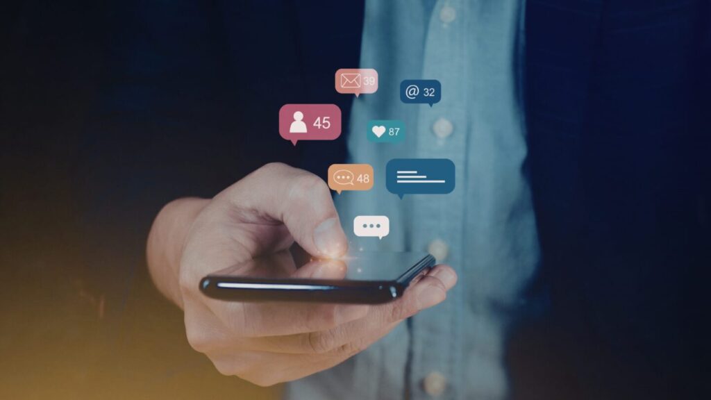 Person using mobile phone with apps open